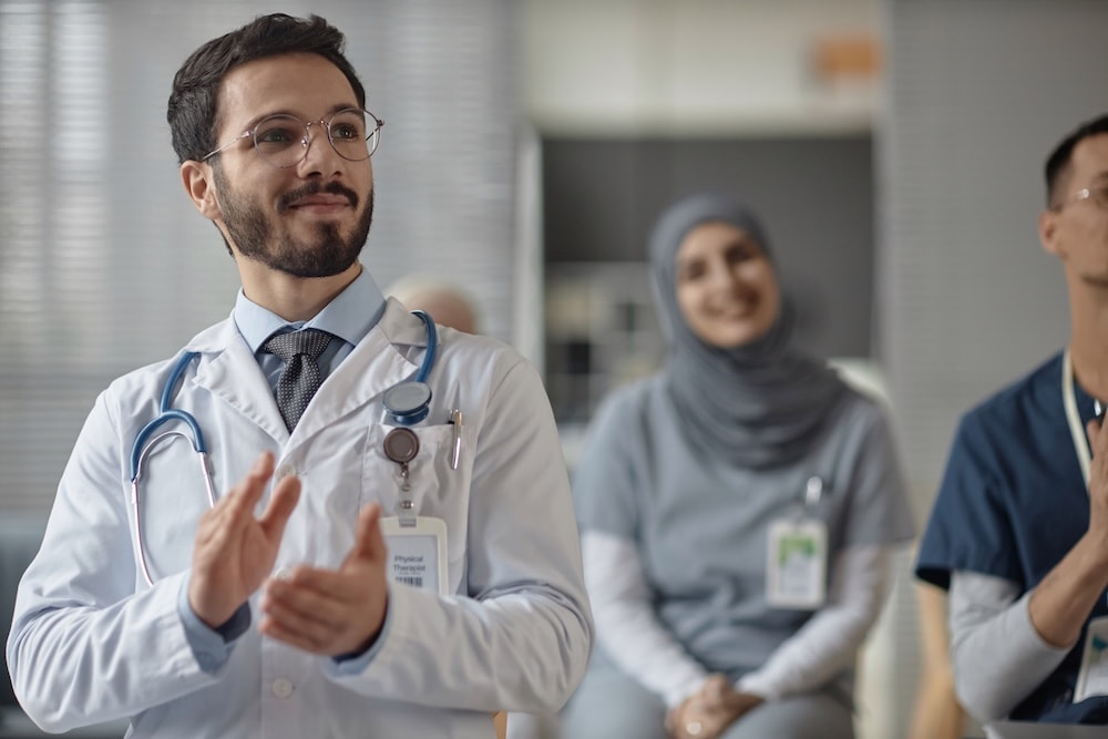A clinician briefing colleagues on a hospital ward